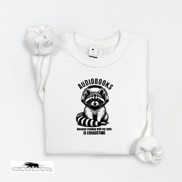 White t-shirt with raccoon graphic and 'audiobooks' text on a white background