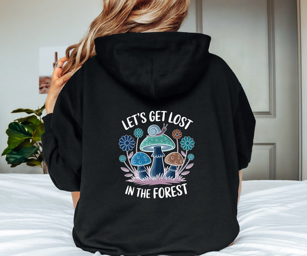 Person wearing a black hoodie with a forest-themed design on the back.
