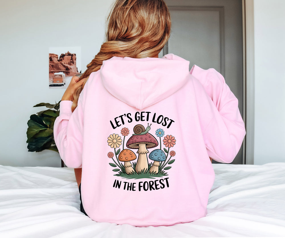 Person wearing a pink hoodie with a forest-themed design and text.