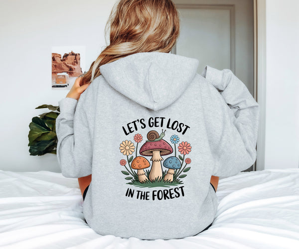 Person wearing a hoodie with a forest-themed design and text.