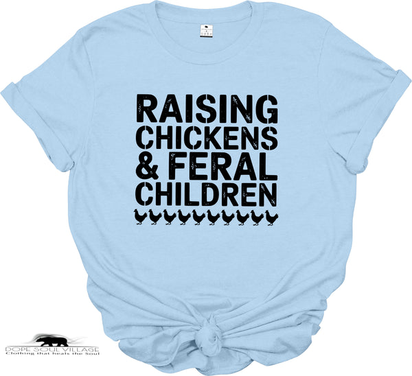 Light blue t-shirt with black text 'RAISING CHICKENS & FERAL CHILDREN' on a white background
