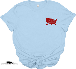 Light blue t-shirt with a red map of the United States and 'Gilead text on a white background.