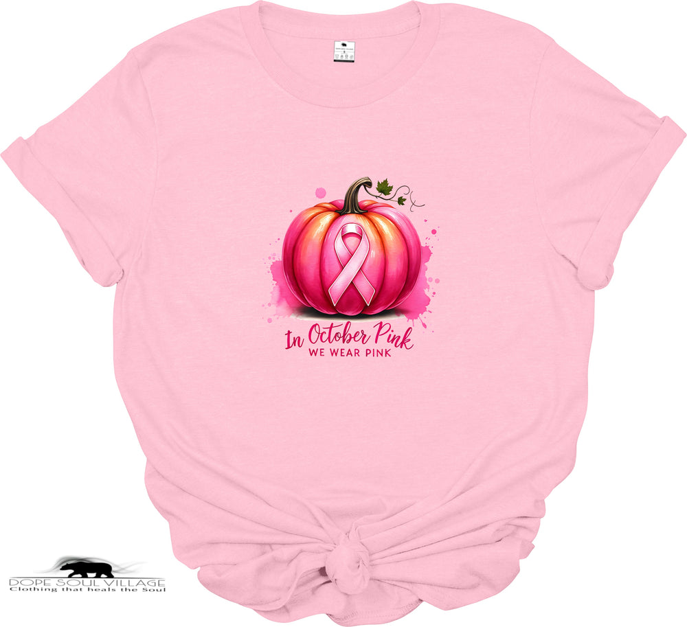 Pink t-shirt with pumpkin and pink ribbon design, featuring 'In October Pink We Wear Pink' text.