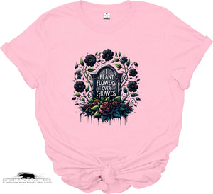 Pink t-shirt with a graphic design of flowers and text on a white background