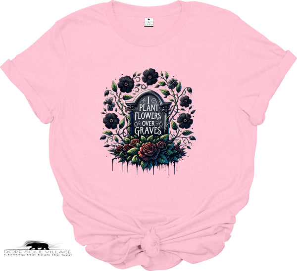 Pink t-shirt with a graphic design of flowers and text on a white background