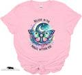 Pink t-shirt with a colorful butterfly graphic and text 'Believe in the magic within you' on a white background.