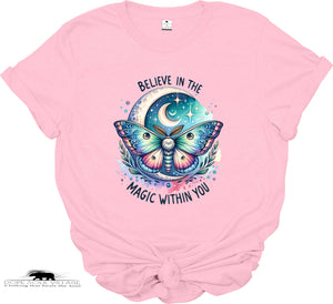 Pink t-shirt with a colorful butterfly graphic and text 'Believe in the magic within you' on a white background.