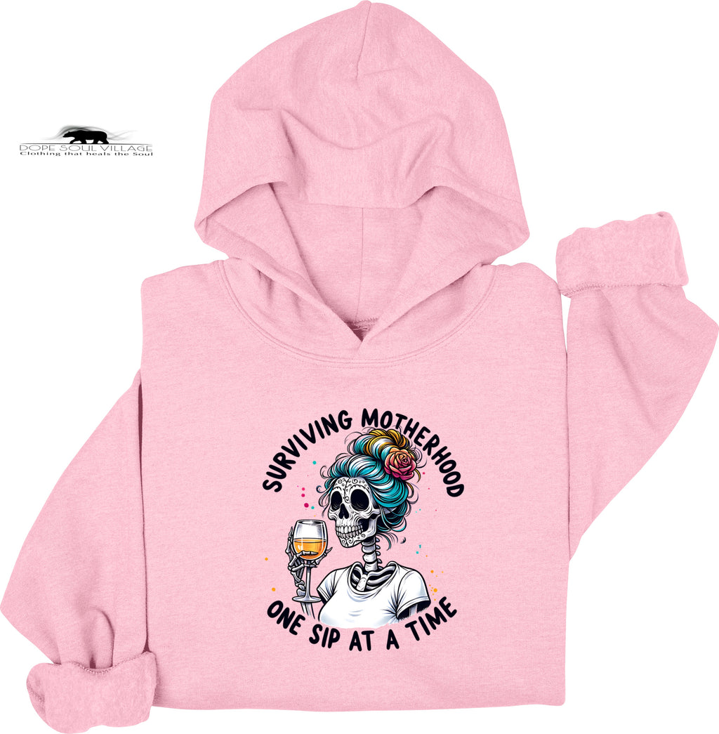 Pink hoodie with a skeleton design and text on a white background