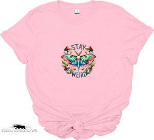 Pink t-shirt with a colorful butterfly graphic and 'Stay Weird' text on a white background.
