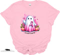 Pink t-shirt with a ghost character wearing a pink ribbon and pumpkins on a white background.