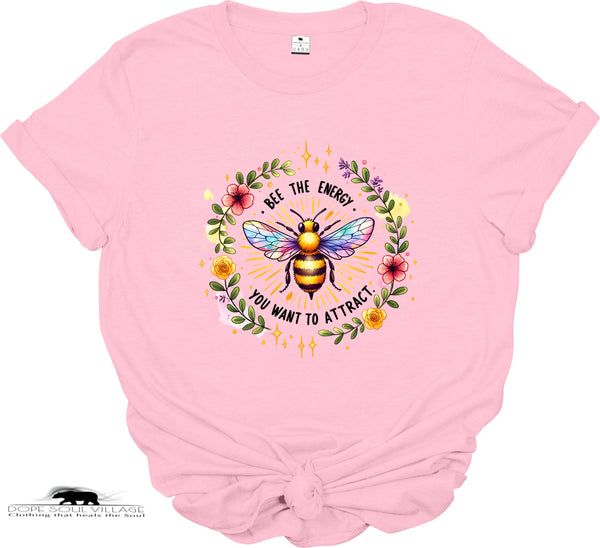Pink t-shirt with a colorful bee graphic and text on a white background