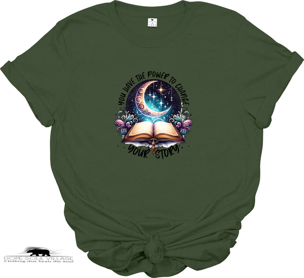 Green t-shirt with a graphic design of an open book, crescent moon, and stars on a white background.