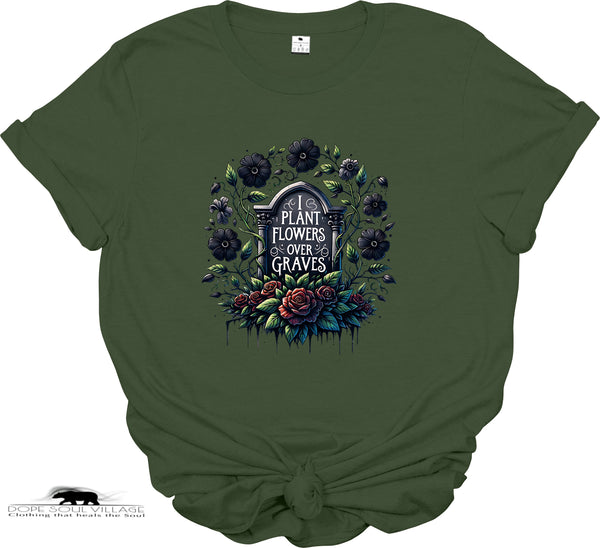 Green t-shirt with floral and gravestone design on a white background