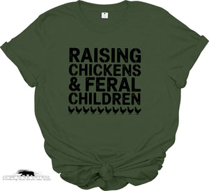 Green t-shirt with black text 'RAISING CHICKENS & FERAL CHILDREN' on a white background