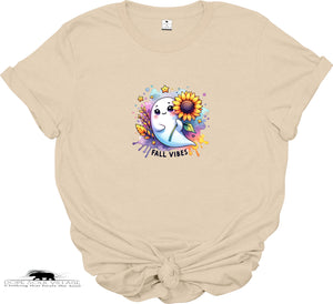 Beige t-shirt with a colorful graphic of a ghost, sunflower, and text 'Fall Vibes' on a white background.