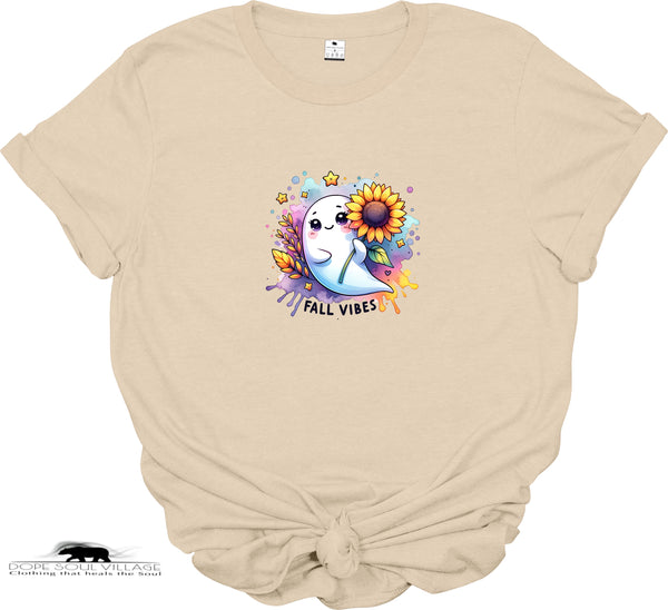 Beige t-shirt with a colorful graphic of a ghost, sunflower, and text 'Fall Vibes' on a white background.