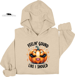 Beige hoodie with a pumpkin graphic and text on a white background