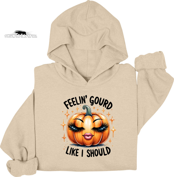 Beige hoodie with a pumpkin graphic and text on a white background