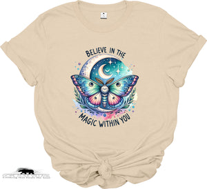 Beige t-shirt with a colorful butterfly graphic and text 'Believe in the magic within you' on a white background.