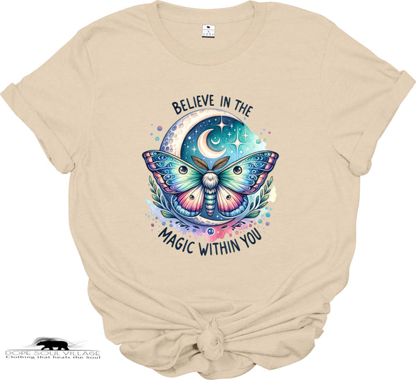 Beige t-shirt with a colorful butterfly graphic and text 'Believe in the magic within you' on a white background.
