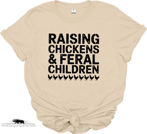Beige t-shirt with black text 'RAISING CHICKENS & FERAL CHILDREN' on a white background
