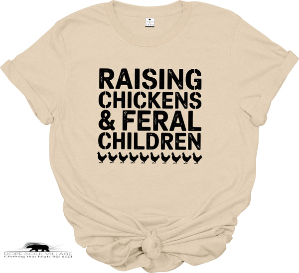 Beige t-shirt with black text 'RAISING CHICKENS & FERAL CHILDREN' on a white background