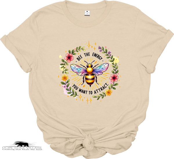 Beige t-shirt with a colorful bee graphic and text on a white background