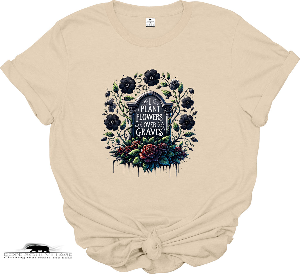 Beige t-shirt with floral and gravestone design on a white background