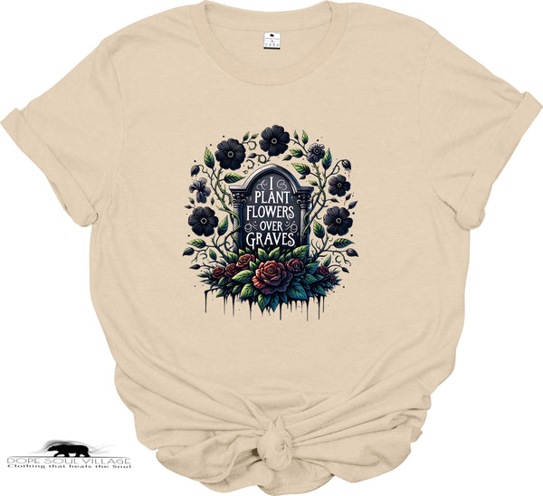 Beige t-shirt with floral and gravestone design on a white background