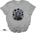 Gray t-shirt with floral and gravestone design on a white background