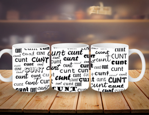 Three white mugs with black text on a wooden surface