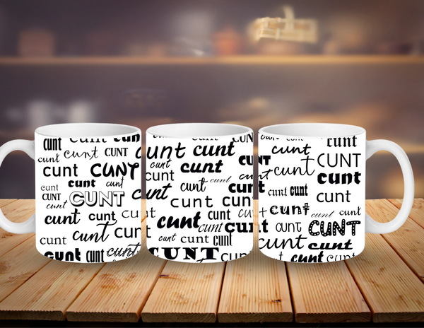 Three white mugs with black text on a wooden surface