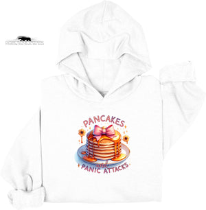 White hoodie with a graphic of pancakes and text 'Pancakes and Panic Attacks' on a white background.