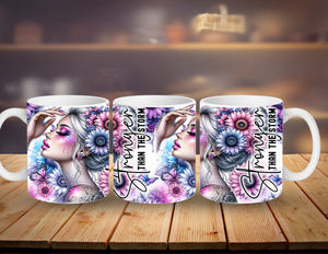 Three mugs with artistic designs and text on a wooden surface.