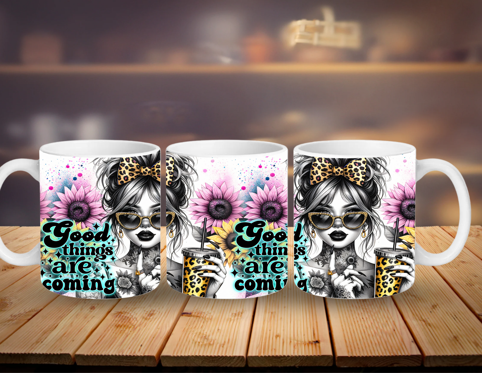 Three mugs with a design of a girl with flowers and text 'Good things are coming' on a wooden surface.