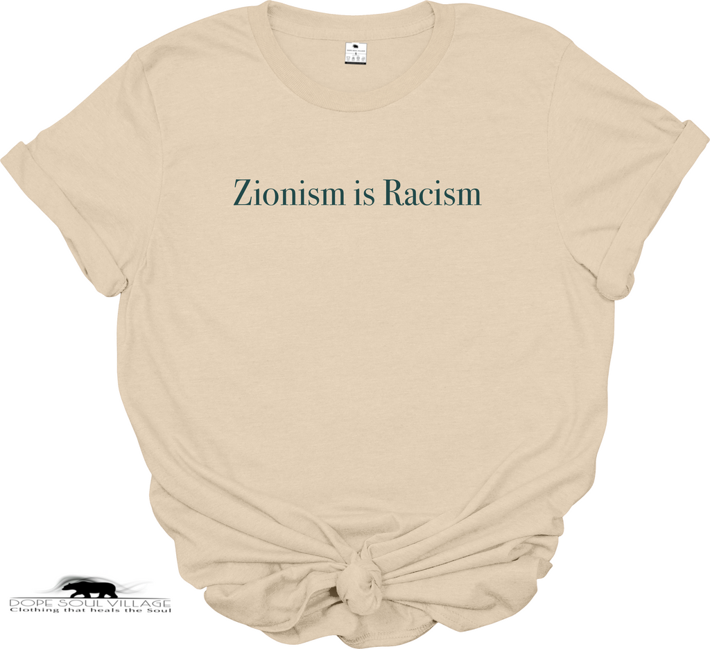 A sand beige short-sleeve t-shirt with the text 'Zionism is Racism' printed in black serif font across the chest. The t-shirt is set against a plain white background, available from Dope Soul Village women's marketplace.